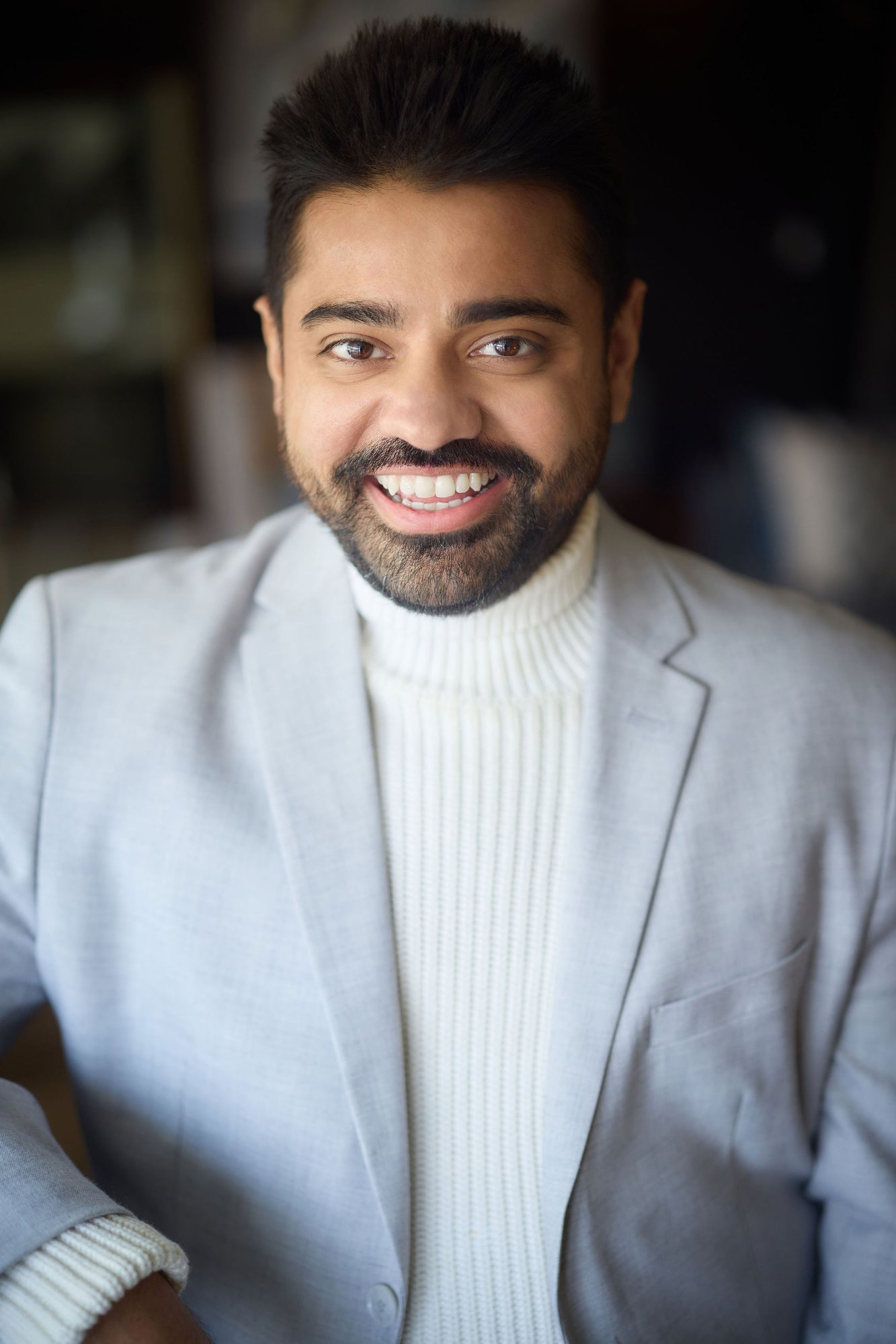 Dan Shaikh smiling - from shy immigrant to visibility expert