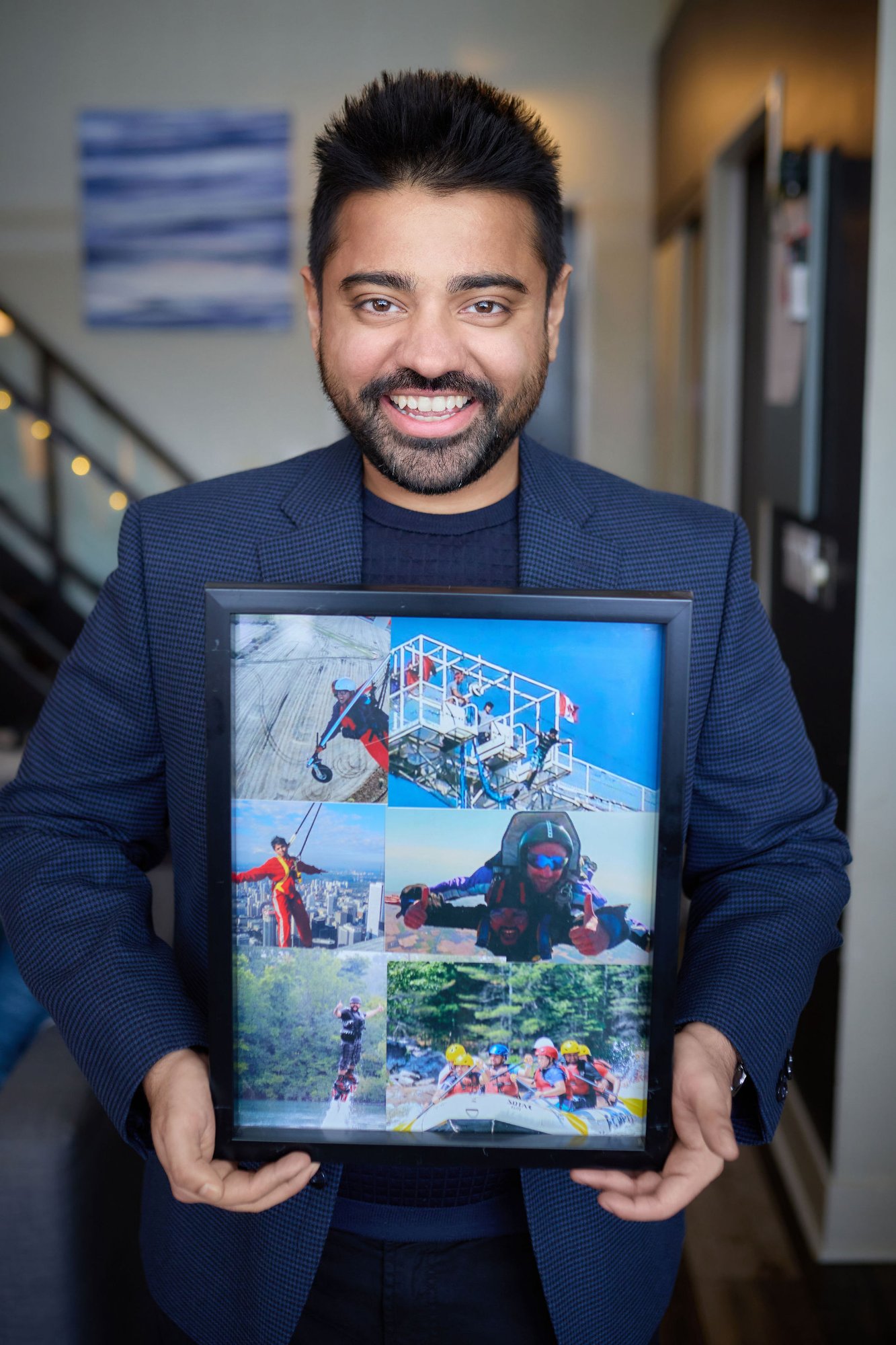 Dan Shaikh holding his bucket list adventure photos